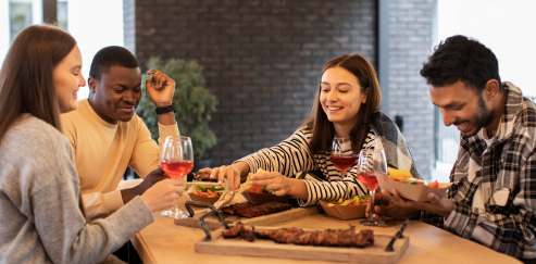 Four friends sharing a homemade meal around a table